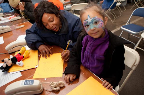 Far Rockaway, N.Y., Nov. 10, 2012 -- FEMA Community Relations specialist, Teisha Jeeter draws pictures with young disaster survivor, Luna Natalia Voss at a Disaster Recovery Center (DRC) in Far Rockaway, New York. The center was set up to assist the needs of Hurricane Sandy survivors. 