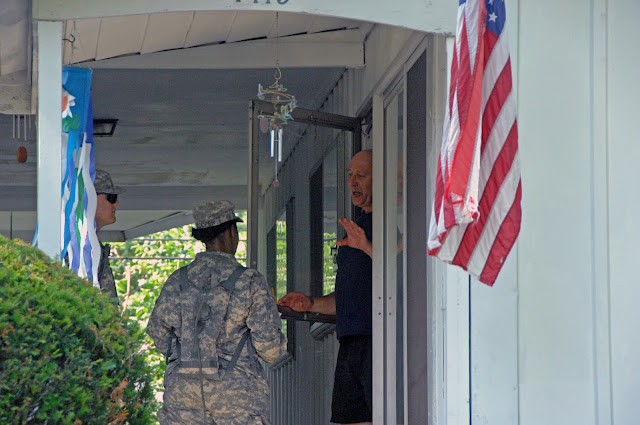 Pvt. Jason Geier (left) and Sgt. Jessica Cooper, of Headquarters and Headquarters Company, 216th Engineer Battalion, talk with Gary Rowe, of Columbus, Ohio, on July 2, 2012. (Ohio National Guard photo by Senior Airman Jordyn Sadowski)